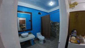 a bathroom with a toilet and a sink and a mirror at Dream Hill Condos & Spa in Puerto Galera