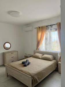 a bedroom with a large bed with a window at Villa Terra Rosa in Kritou Terra +15 photos