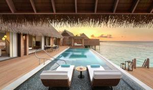 a villa with a swimming pool in the ocean at Waldorf Astoria Maldives Ithaafushi in South Male Atoll