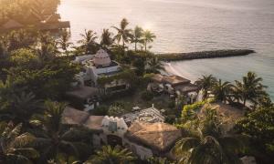 an aerial view of a resort with palm trees and the ocean at Waldorf Astoria Maldives Ithaafushi in South Male Atoll