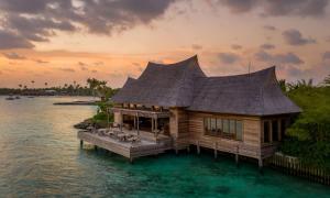 a house on a dock in the water at Waldorf Astoria Maldives Ithaafushi in South Male Atoll