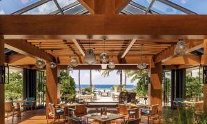 a restaurant with a view of the ocean at Waldorf Astoria Maldives Ithaafushi in South Male Atoll