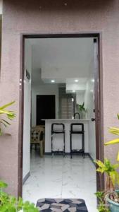a kitchen with two bar stools and a counter at Lumina Home Dumaguete in Dumaguete +16 photos
