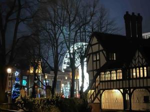 a building with a christmas tree in the background at night at Spacious and homely city centre studio in Coventry