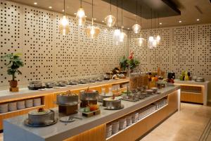 a restaurant with a counter with pots and pans at Hilton San Salvador in San Salvador