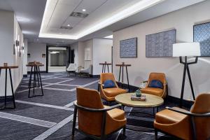a waiting room with chairs and a table at Cumberland House Knoxville, Tapestry Collection by Hilton in Knoxville