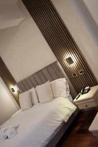 a bedroom with a large white bed and a nightstand at CASA REALE in Frigento