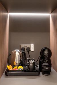 a coffee maker and a tea kettle on a counter at Howard House Hotel in Mdina