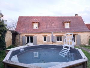 a house with a swimming pool in front of a house at La Maison De Jade in Meyrals