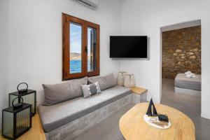 a living room with a couch and a table at Evgenias Sea House in Symi