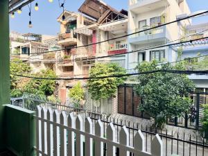 a white fence in front of a building at Homestay Four P Binh Thanh in Ho Chi Minh City