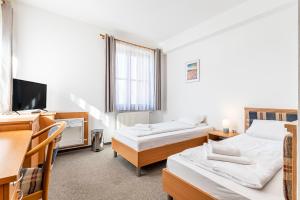 Voodi või voodid majutusasutuse Garni Hotel Gavurky toas