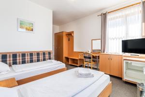 Voodi või voodid majutusasutuse Garni Hotel Gavurky toas