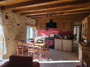 a kitchen with a table and chairs in a room at La Maison De Jade in Meyrals