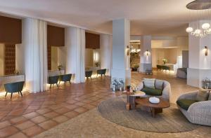 a living room with a couch and a table at Conrad Chia Laguna Sardinia in Chia