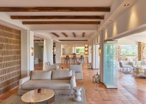 a living room with a couch and a table at Conrad Chia Laguna Sardinia in Chia