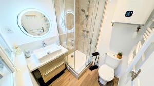 a small bathroom with a sink and a toilet at Le vintage RDC in Abbeville +18 photos