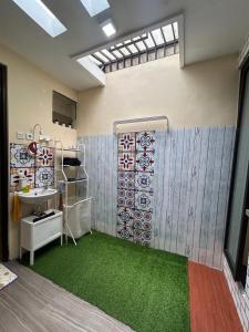 a bathroom with a sink and green carpet at Dea's House Homestay in Blimbing +19 photos