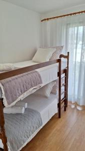 Postel nebo postele na pokoji v ubytování Apartmani I & J Šerić