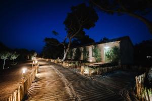 a building with lights on a street at night at Le Hameau Des Pesquiers Ecolodge & Spa, Curio Collection By Hilton in Hyères