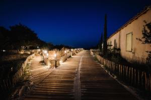 a street at night with lights on it at Le Hameau Des Pesquiers Ecolodge & Spa, Curio Collection By Hilton in Hyères