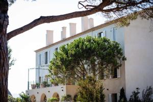 a building with a tree in front of it at Le Hameau Des Pesquiers Ecolodge & Spa, Curio Collection By Hilton in Hyères