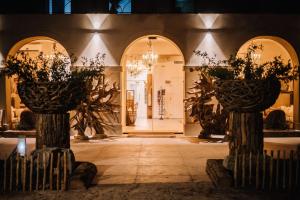 a lobby with two pillars with plants on them at Le Hameau Des Pesquiers Ecolodge & Spa, Curio Collection By Hilton in Hyères
