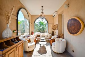 a living room with a lot of chairs and a table at Le Hameau Des Pesquiers Ecolodge & Spa, Curio Collection By Hilton in Hyères