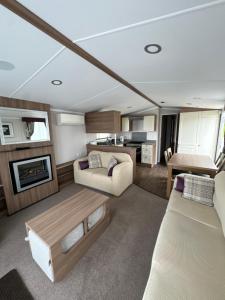 a living room with a couch and a table at Waterfront Kent coast in Rochester