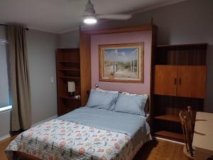 a bedroom with a bed and a painting on the wall at Ranch with Cactuses in Millsboro +11 photos