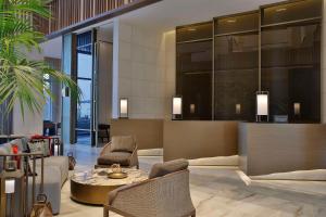a lobby of a hotel with a table and chairs at Conrad Rabat Arzana in Rabat
