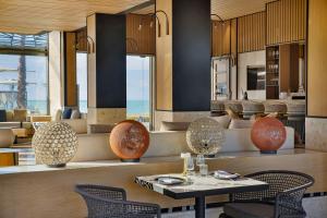 a dining room with a table and chairs at Conrad Rabat Arzana in Rabat