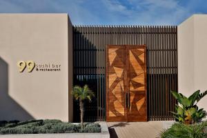 a wooden door on the side of a building at Conrad Rabat Arzana in Rabat