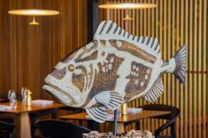 a statue of a fish on a table in a restaurant at Conrad Rabat Arzana in Rabat