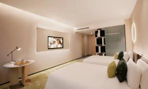 Postelja oz. postelje v sobi nastanitve Wuhan Hazens Hotel
