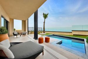 a living room with a swimming pool and a patio at Conrad Rabat Arzana in Rabat