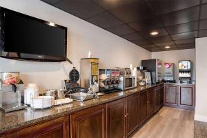 cocina con encimera grande y TV en la pared en Super 8 by Wyndham Daleville-Fort Novosel, en Daleville