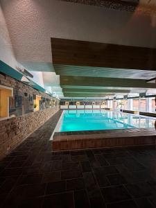 a large swimming pool in a building at Waldblick - Bad Harzburg - Schwimmbad und Sauna in Bad Harzburg