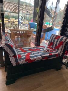 a couch sitting in a living room next to a window at Le Verdier in Chauffailles +11 photos