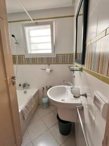 a bathroom with a sink and a tub and a toilet at Cozy & Top Apartment, Wi-Fi, Private Garden, Sea Side in Hergla