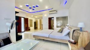 a bedroom with a bed and a living room at Willo stays beach cottage in Kannur