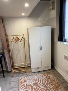 a bathroom with a white cabinet and a rug at Dieppe Coeur de Ville in Dieppe