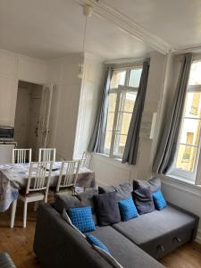 a living room with a couch and a table at Dieppe Coeur de Ville in Dieppe