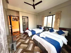 A bed or beds in a room at Hotel Immortal Inn