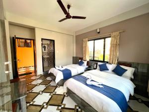 A bed or beds in a room at Hotel Immortal Inn