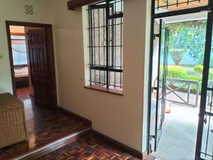 an open door to a room with a patio at BnB chez Joep - corner Guestroom in Nairobi +2 photos