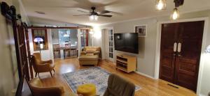 a living room with a flat screen tv and a couch at Ranch with Cactuses in Millsboro