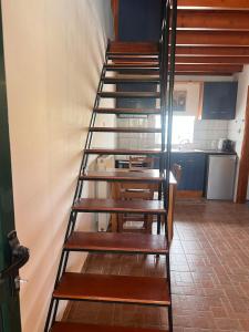 a spiral staircase in a room with a kitchen at Monolithos in Város +11 photos