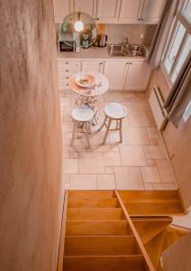 Una pequeña cocina con una mesa y dos taburetes. en Dreaming of Tuscany, en Aegina Town