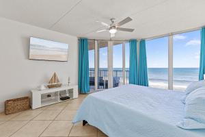 a bedroom with a bed and a view of the ocean at The Ocean 502 in New Smyrna Beach